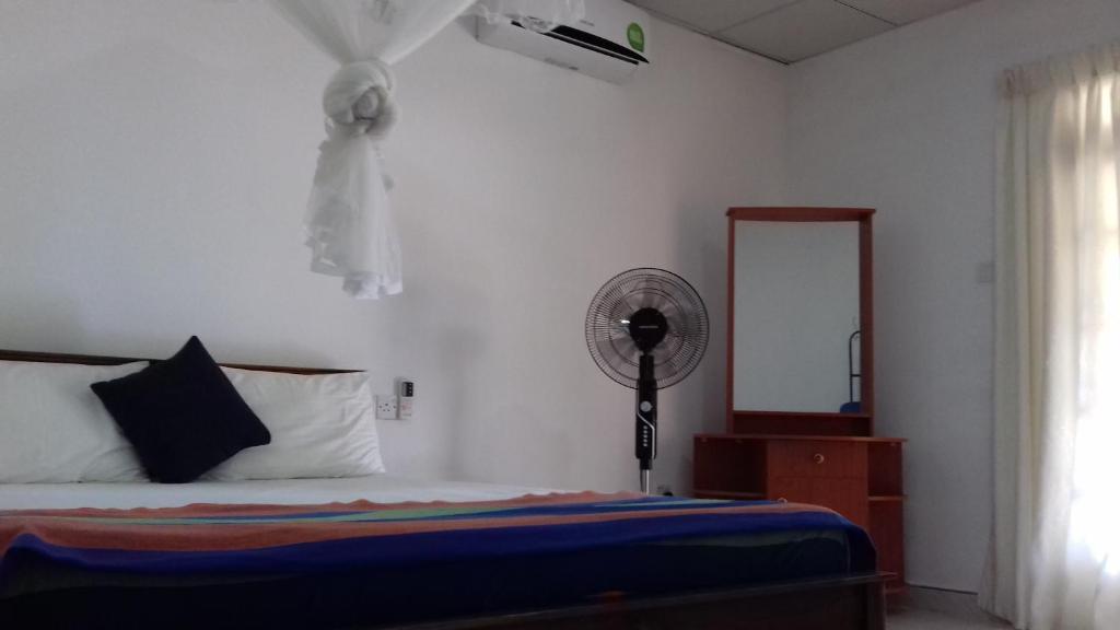 Postel nebo postele na pokoji v ubytování Sigiri Shen Residence