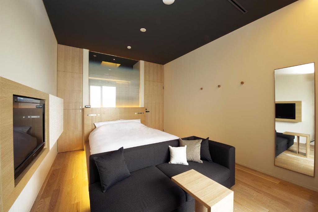 Postel nebo postele na pokoji v ubytování hotel kanra kyoto