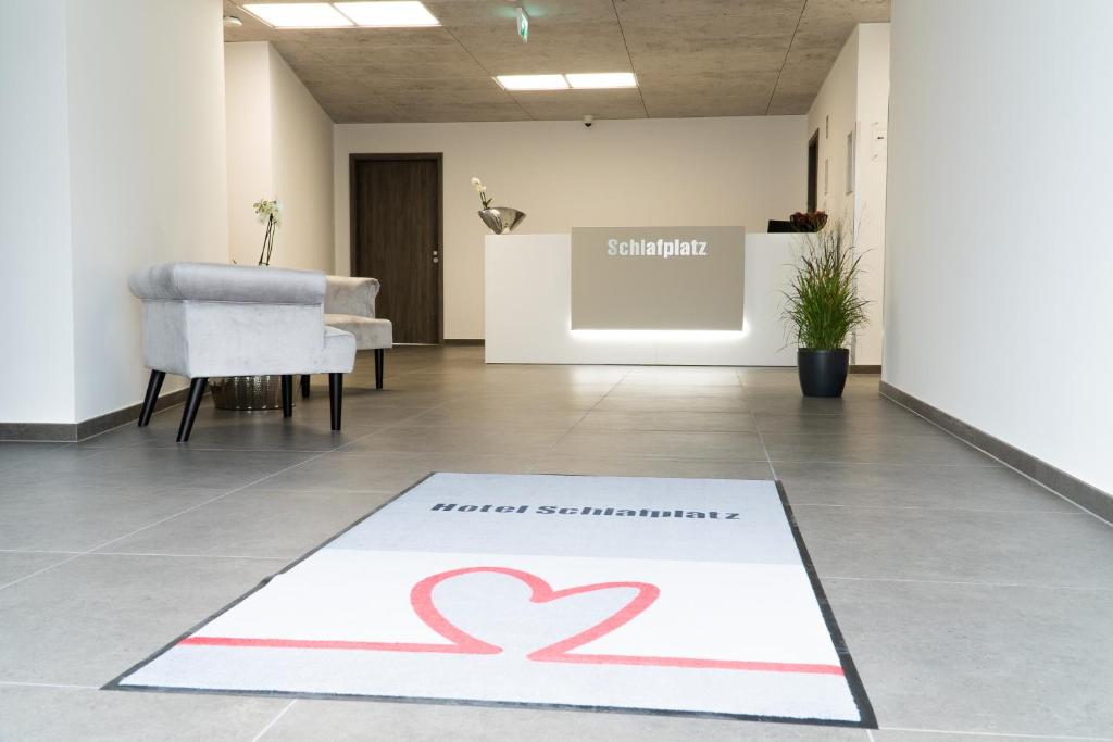 a red heart rug on a floor in a room at Hotel Schlafplatz in Rodgau