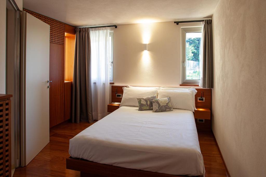 a bedroom with a bed with two pillows on it at Il Leccio - Luxury Resort Portofino Monte in Santa Margherita Ligure