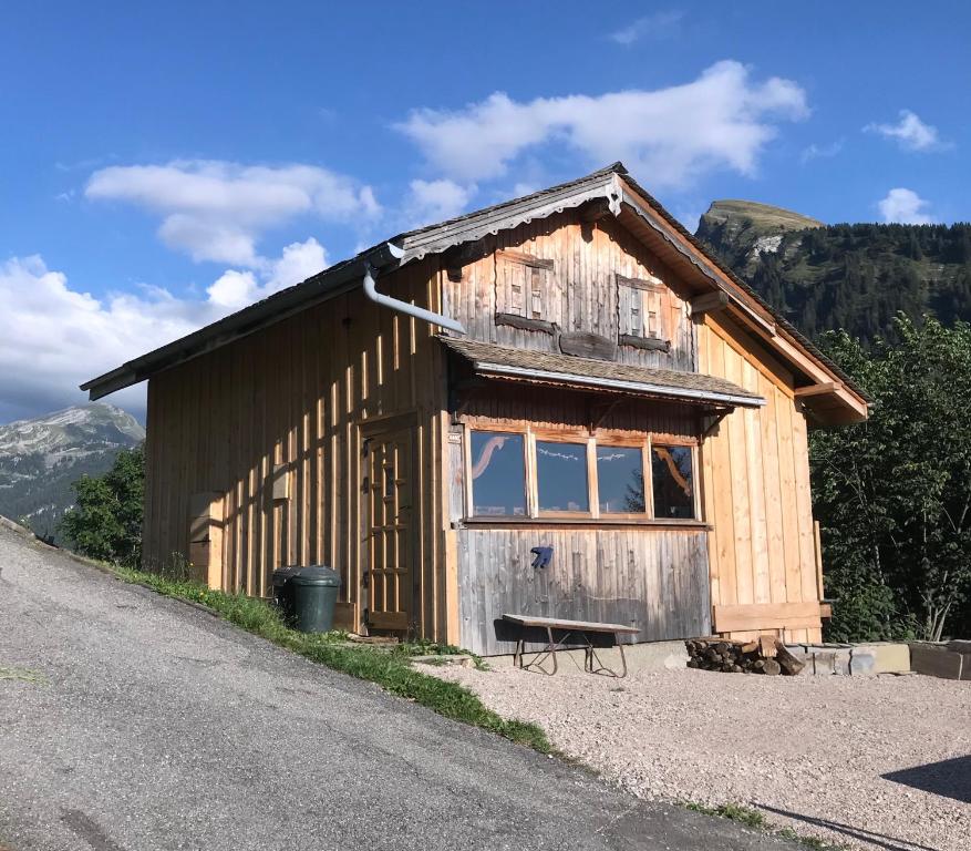 a small wooden building on the side of a road at Mazot Hirondelle in Morzine