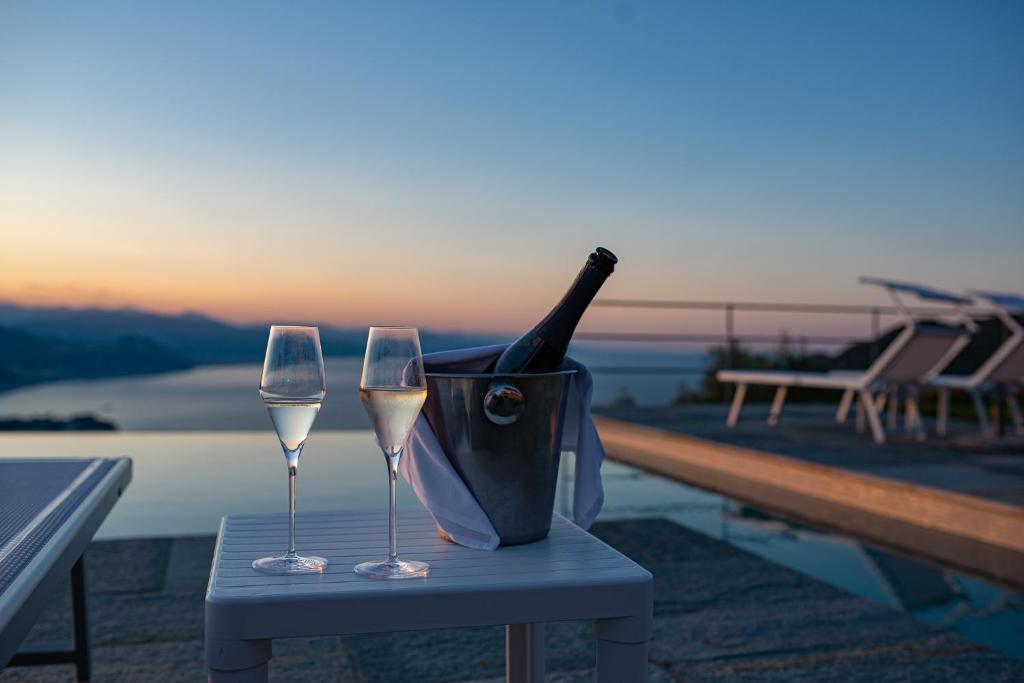 a bottle of champagne and two glasses on a table at Il Leccio - Luxury Resort Portofino Monte in Santa Margherita Ligure