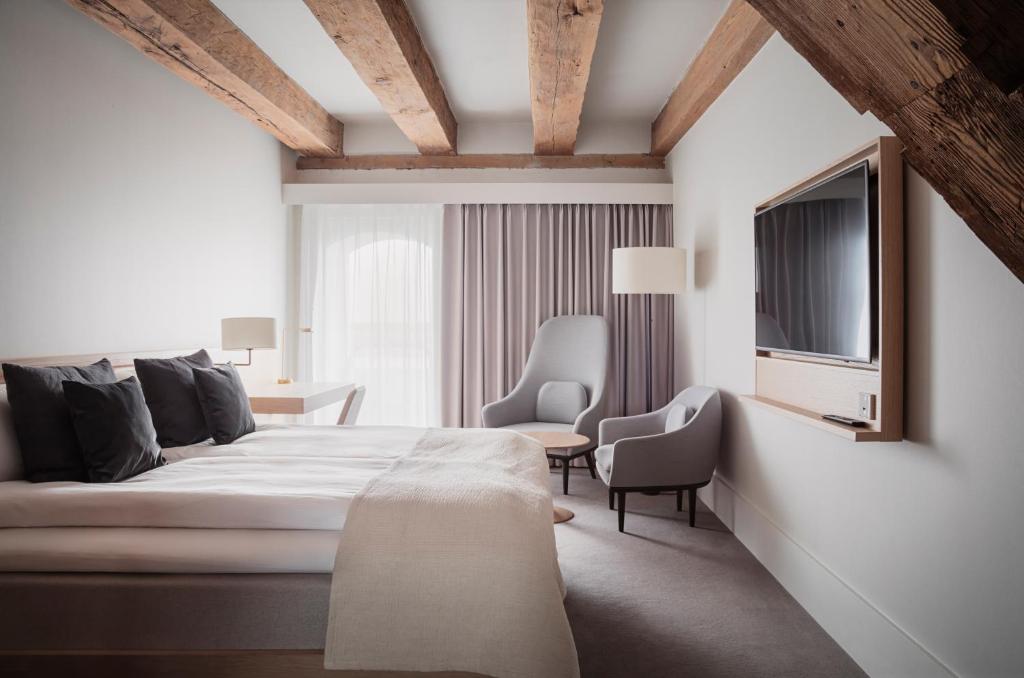 a bedroom with a bed and a chair and a tv at Copenhagen Admiral Hotel in Copenhagen