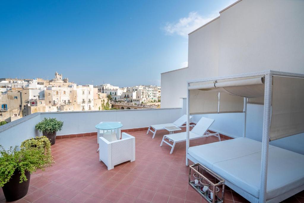 a balcony with beds and a view of a city at Covo dei Saraceni in Polignano a Mare