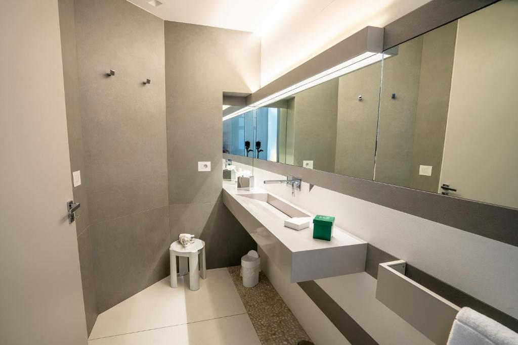 a bathroom with a sink and a large mirror at Covo dei Saraceni in Polignano a Mare