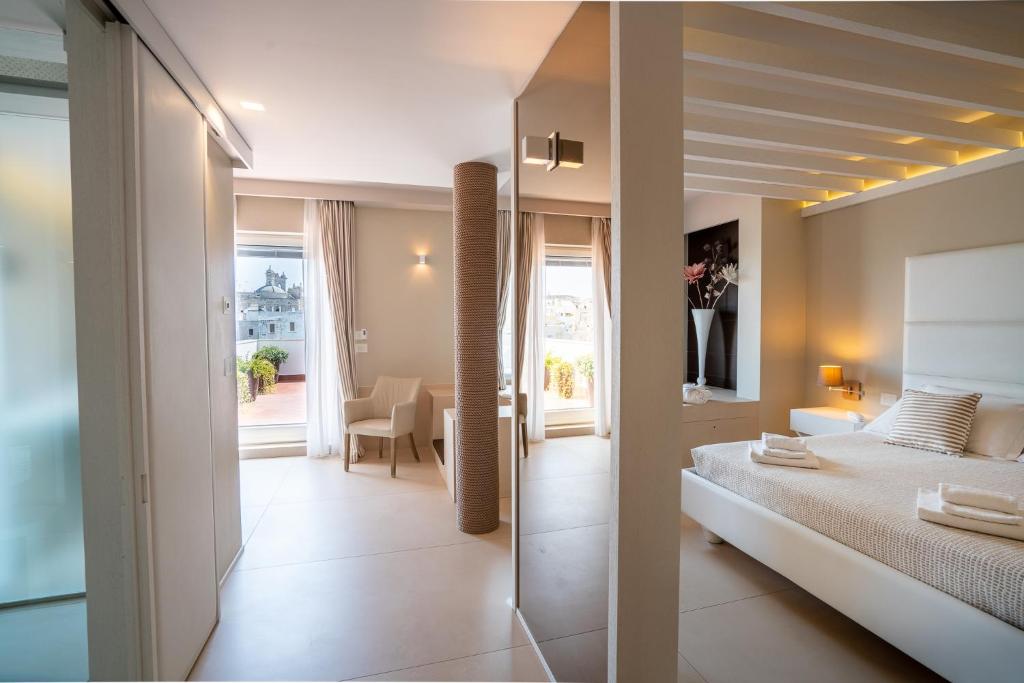 a bedroom with a bed and a view of a room at Covo dei Saraceni in Polignano a Mare