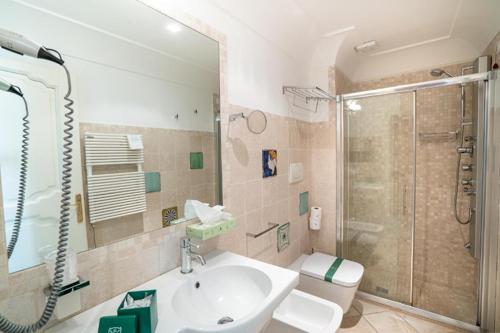 a bathroom with a sink and a shower at Covo dei Saraceni in Polignano a Mare