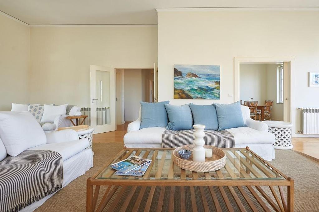 a living room with two couches and a coffee table at Saboia -Spacious Gorgeous Apartment in Monte Estoril