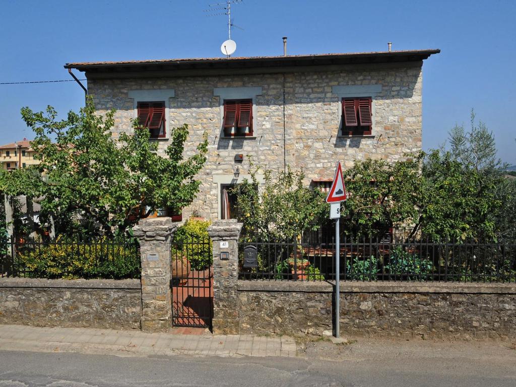 a stone house with a gate and a fence at Apartment Matteuzzi by Interhome in Mercatale Val Di Pesa