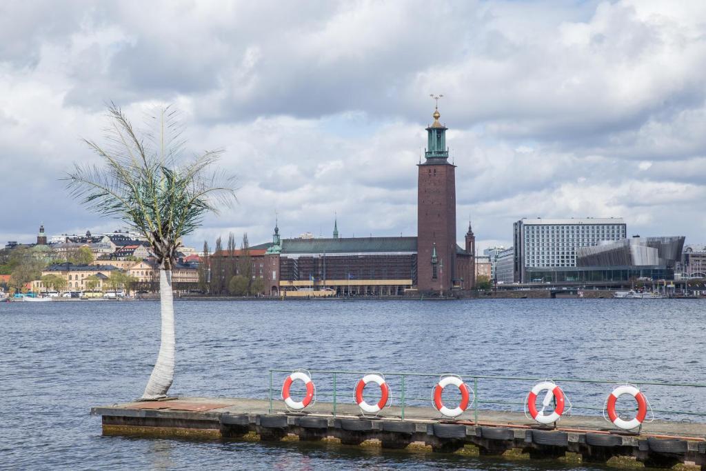 a pier with red and white life rings in the water at Den Röda Båten in Stockholm
