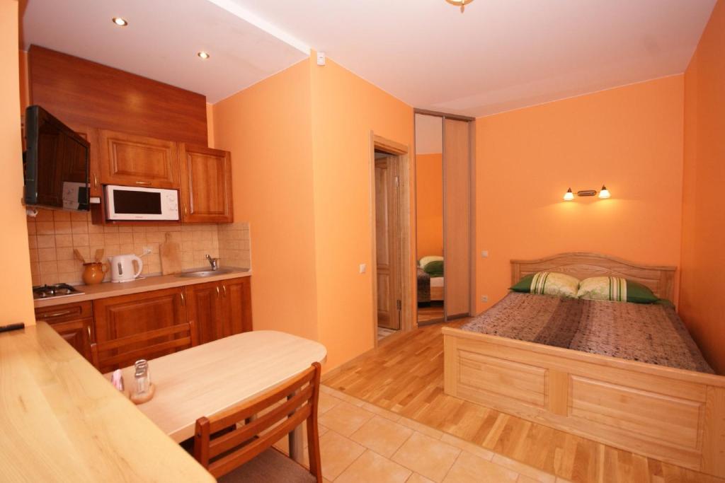 a bedroom with a large bed in a kitchen at Roberto Vila in Palanga