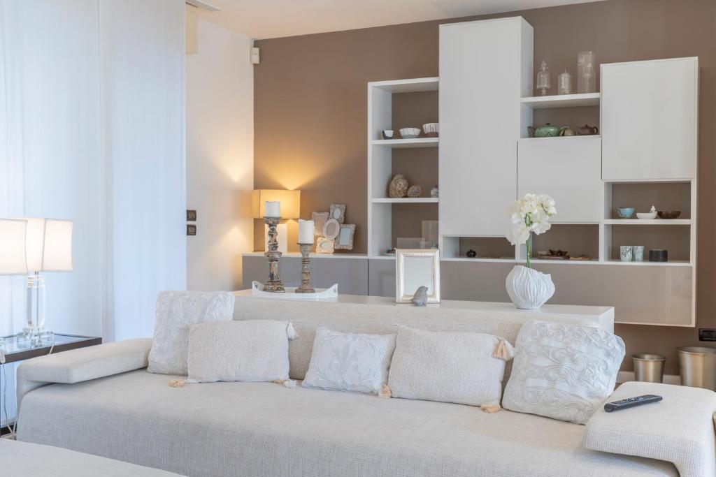 a living room with a couch and a table at Teatro Nuovo Apartment with Free Parking in Udine