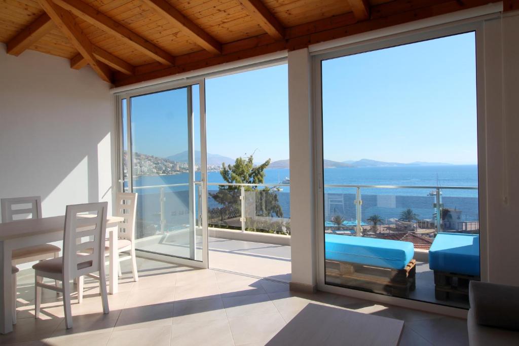 a dining room with a view of the ocean at Kristina Hotel in Sarandë