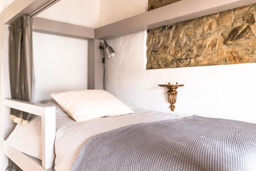 a bedroom with a bed with a wall art at Bohemian Antique Guesthouse in Odeceixe