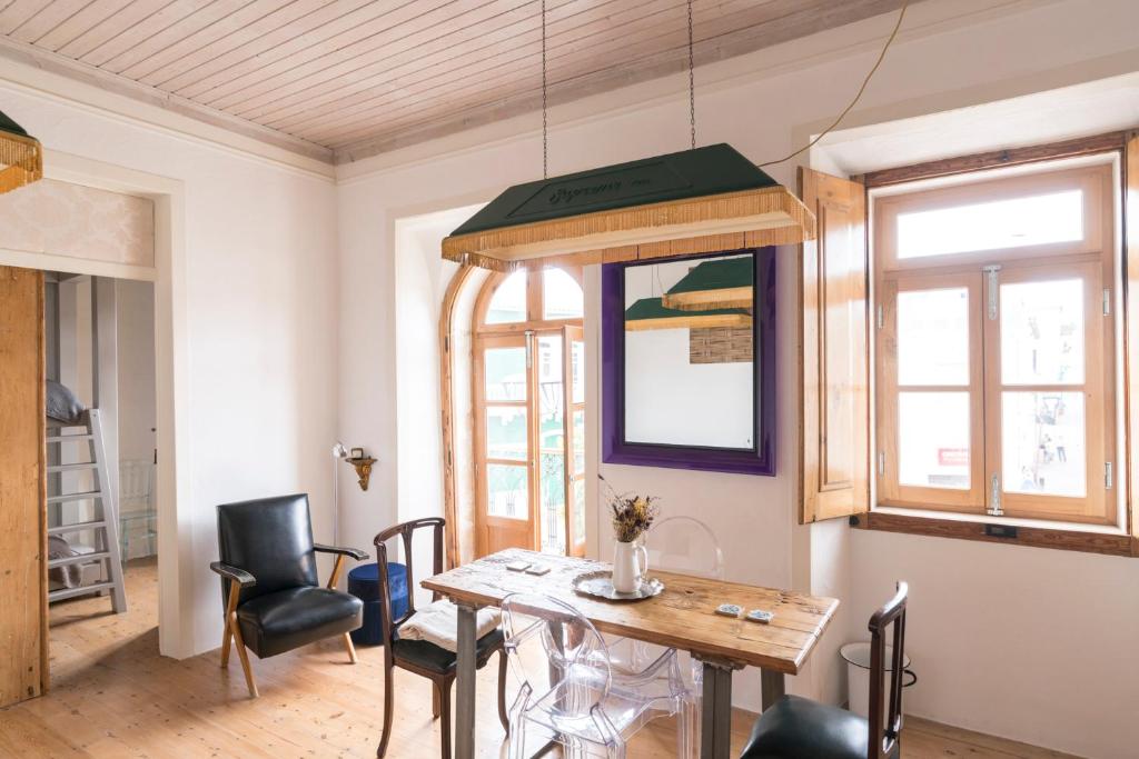 a dining room with a table and chairs at Bohemian Antique Guesthouse in Odeceixe