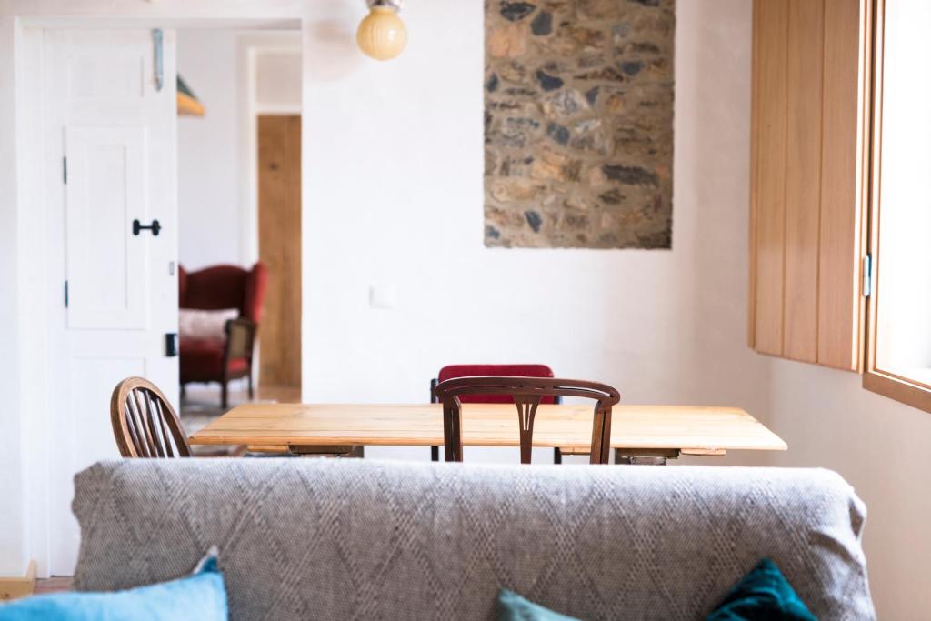 a living room with a table and a couch at Bohemian Antique Guesthouse in Odeceixe