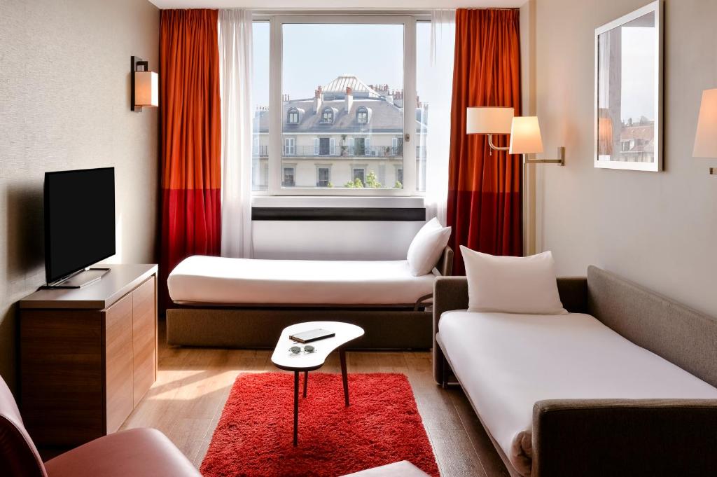 TV a/nebo společenská místnost v ubytování Aparthotel Adagio Genève Mont-Blanc