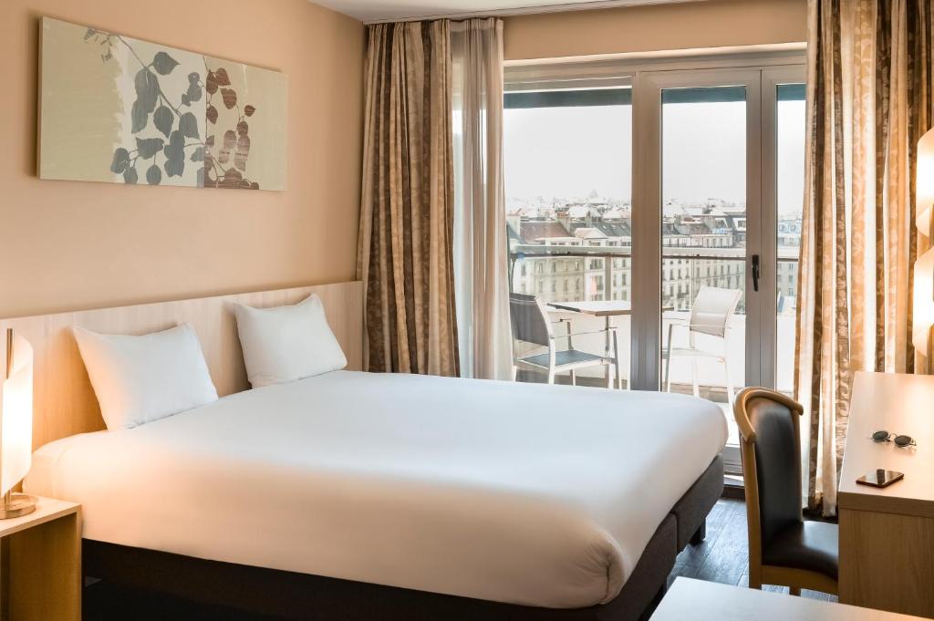 Postel nebo postele na pokoji v ubytování Aparthotel Adagio Genève Mont-Blanc