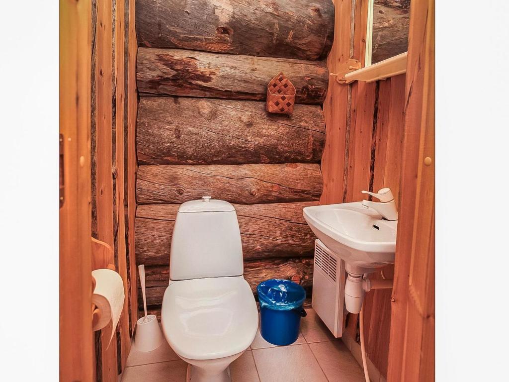 a bathroom with a toilet and a sink at Holiday Home Luostonseita 3 by Interhome in Luosto