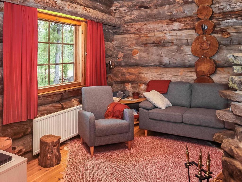 a living room with a couch and two chairs at Holiday Home Luostonseita 3 by Interhome in Luosto