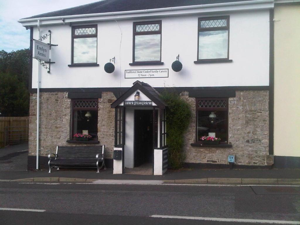a building with a bench in front of it at Emlyn Arms in Llanarthney
