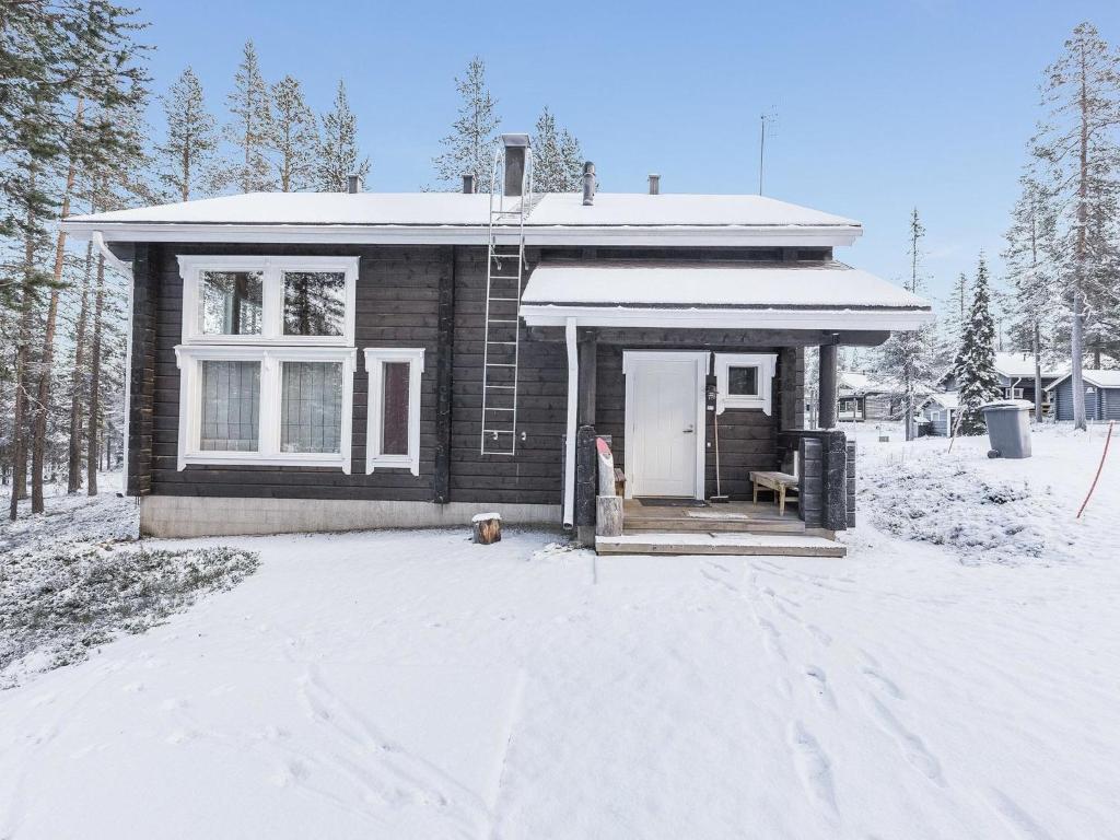 a small house with a porch in the snow at Holiday Home Uuvana by Interhome in Äkäslompolo
