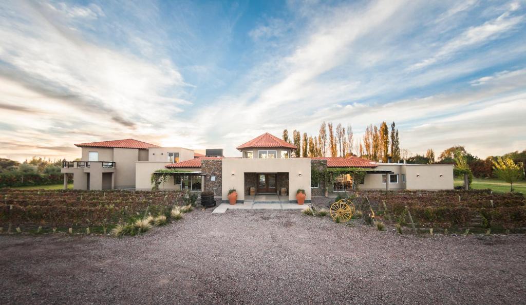 a large white house with a fence in front of it at Villa Mansa in Vistalba