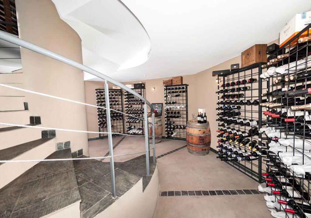 a wine cellar with a staircase and a wine tasting room at Villa Mansa in Vistalba