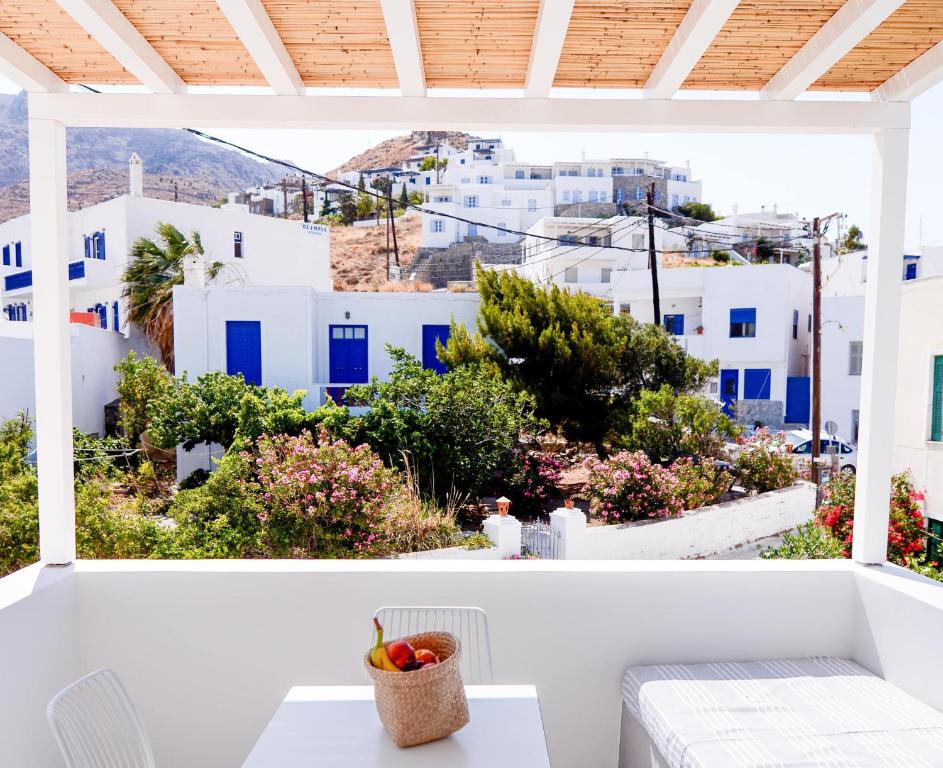 a view from the balcony of a house with blue and white buildings at Pénde Suites in Livadion
