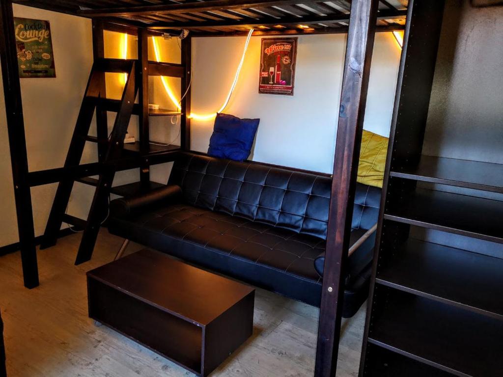 ein Wohnzimmer mit einem Sofa und 2 Etagenbetten in der Unterkunft Mini Studio de 13 m2 avec terrasse 15 mn centre Nimes in Nîmes