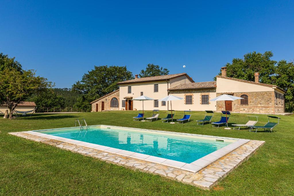 a swimming pool in the yard of a house at Casa Gabry in Sarteano