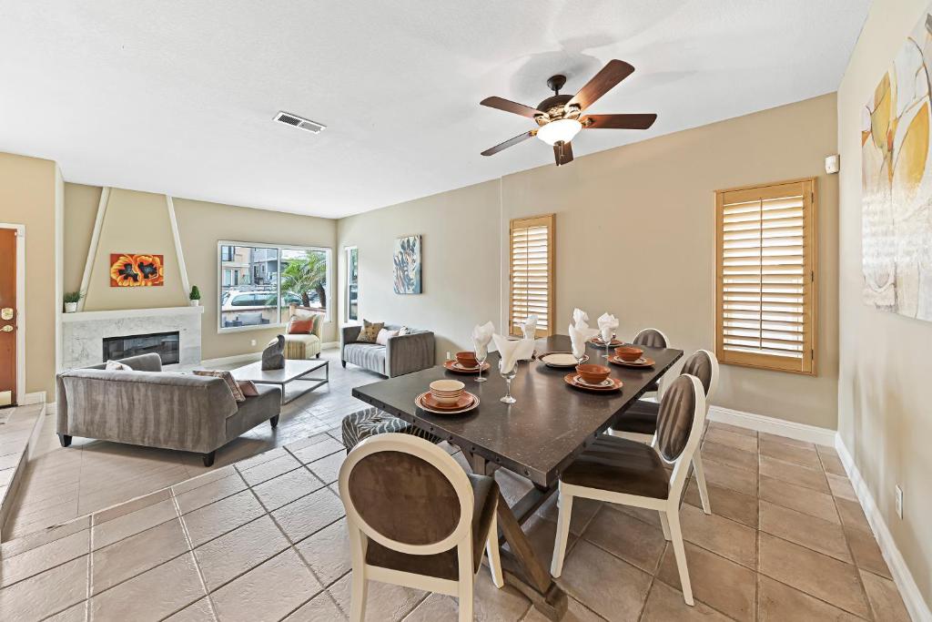 a living room with a dining table and a ceiling fan at 253 Four Bedroom in Huntington Beach