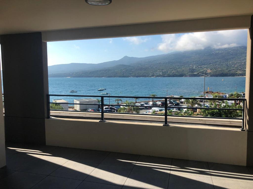 a view of the ocean from a balcony at T3 vue mer in Propriano