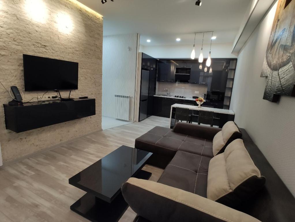 a living room with a couch and a tv at Tbilisi App 3 in Tbilisi City