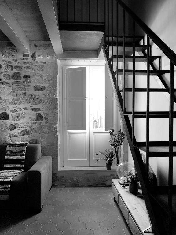 a living room with a staircase and a window at acquarello in Syracuse