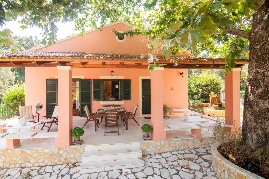 a patio with a table and chairs in front of a house at Villa Magia in Ipsos