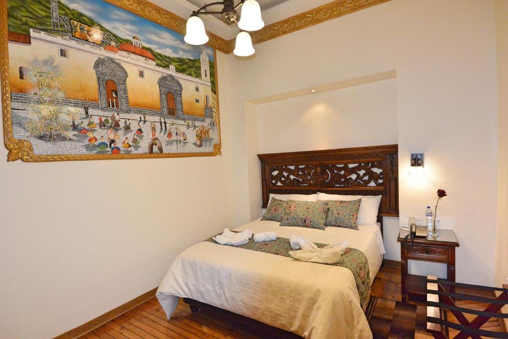 Postel nebo postele na pokoji v ubytování Hotel La Basílica Quito