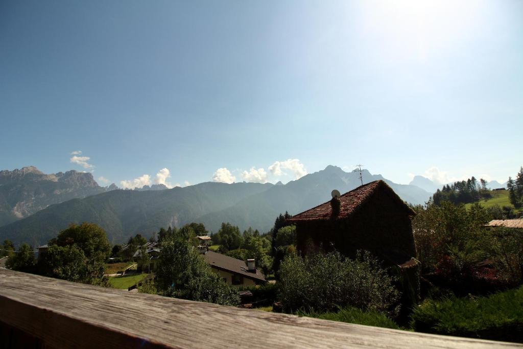 a view of the mountains from the balcony of a house at Nonostantetutto B&B in Pieve di Cadore