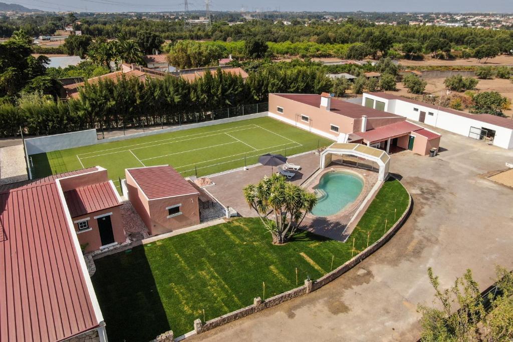 an aerial view of a house with a tennis court at Quinta do Paraíso in Palmela