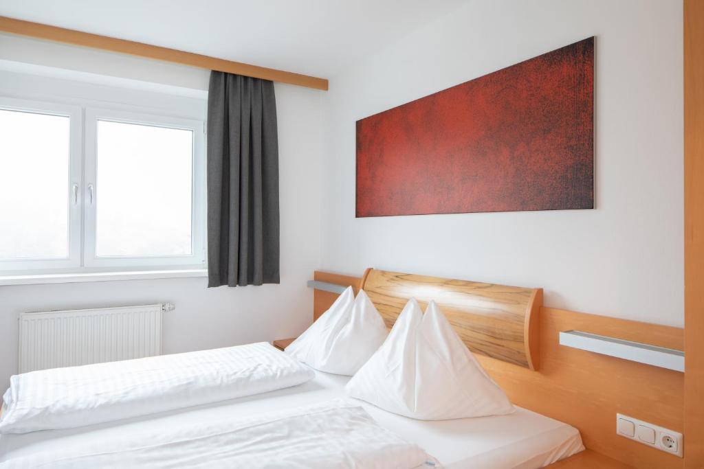 Postel nebo postele na pokoji v ubytování Sunshine Appartements Schilchegger