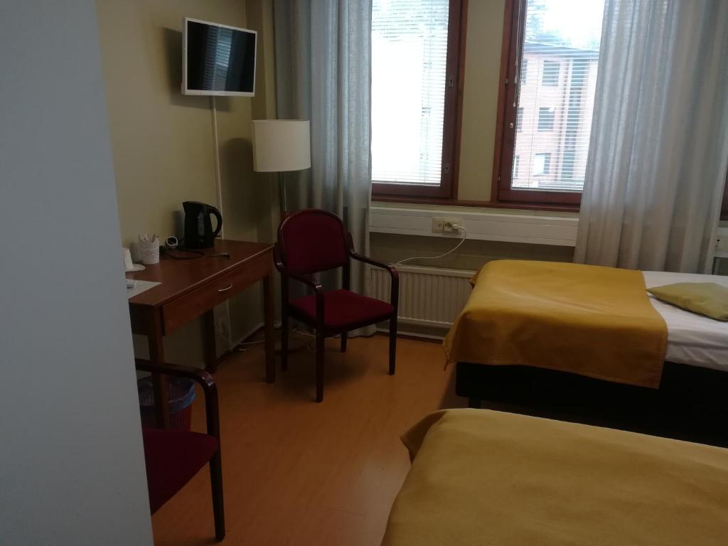 Postel nebo postele na pokoji v ubytování Hotelli Pogostan Hovi