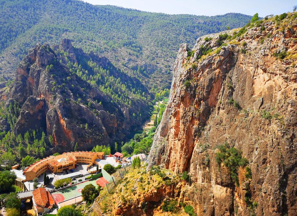 a view of a mountain with a building on it at Hotel restaurante Felipe II in Ayna