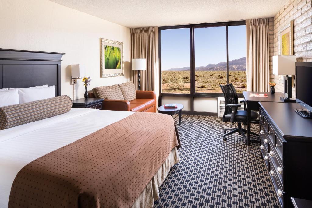 
a hotel room with two beds and a desk at Kayenta Monument Valley Inn in Kayenta
