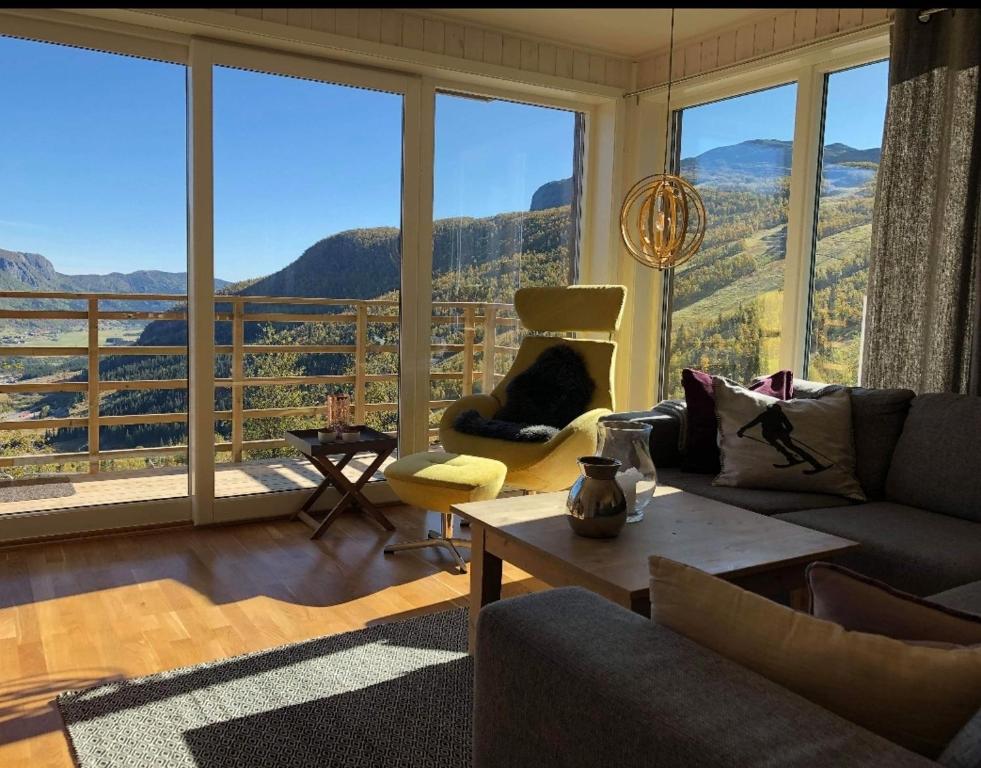 a living room with a view of a mountain at Skarsnuten Panorama 61, Hemsedal in Hemsedal