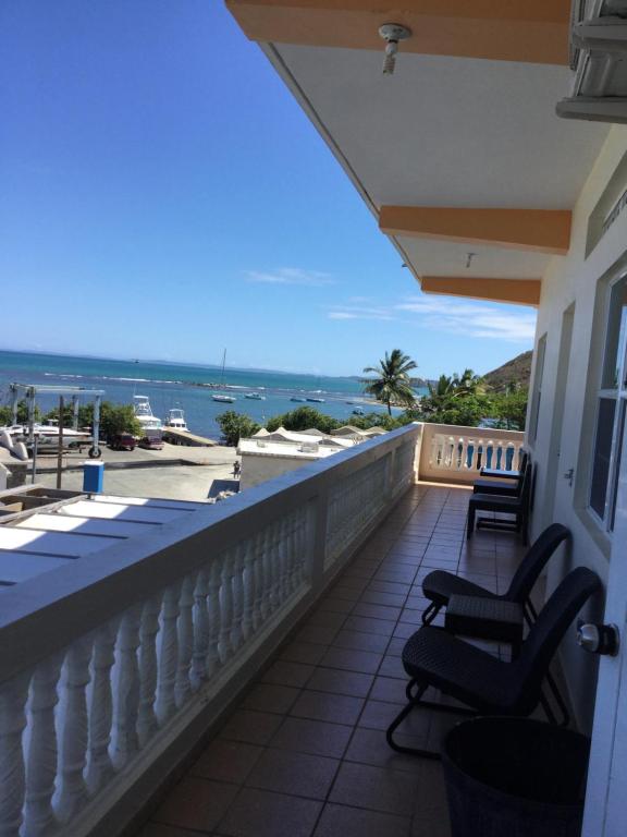 a balcony with chairs and a view of the ocean at Sueños del Mar in Fajardo