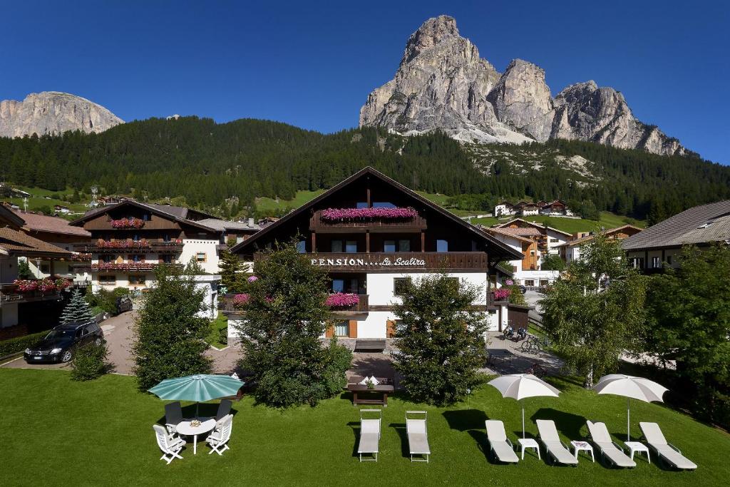 a resort with a mountain in the background at Mountain B&B - La Scalira in Corvara in Badia