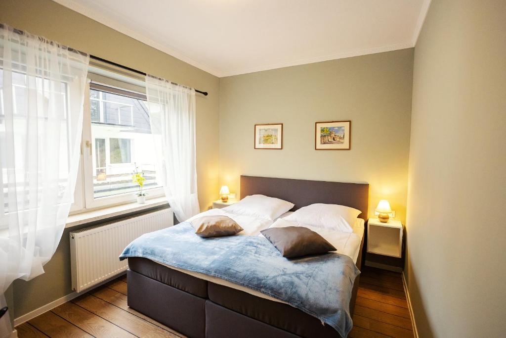 a bedroom with a bed with two pillows on it at Bergoase in Bad Lauterberg