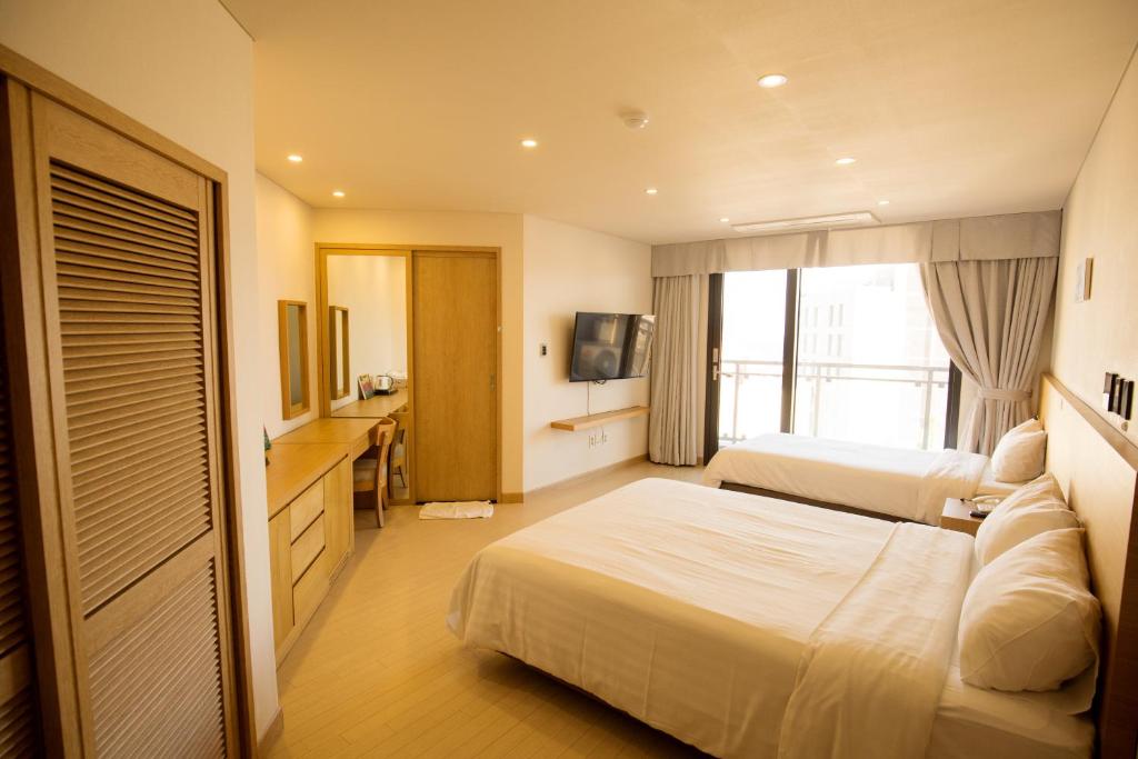 Postel nebo postele na pokoji v ubytování BK Hotel Jeju