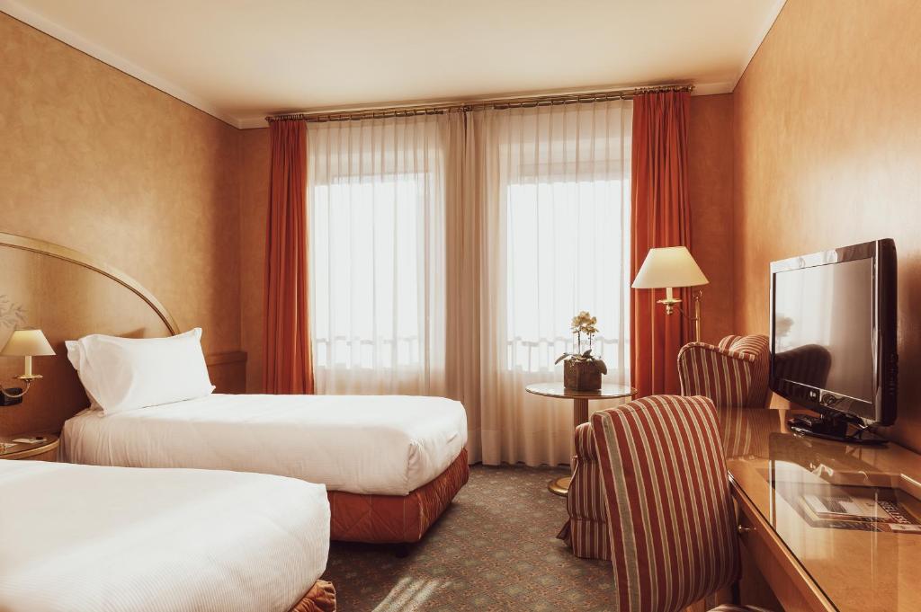Postel nebo postele na pokoji v ubytování Agora' Palace Hotel