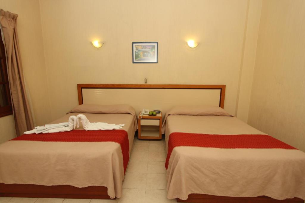 Postel nebo postele na pokoji v ubytování Hotel Ferri